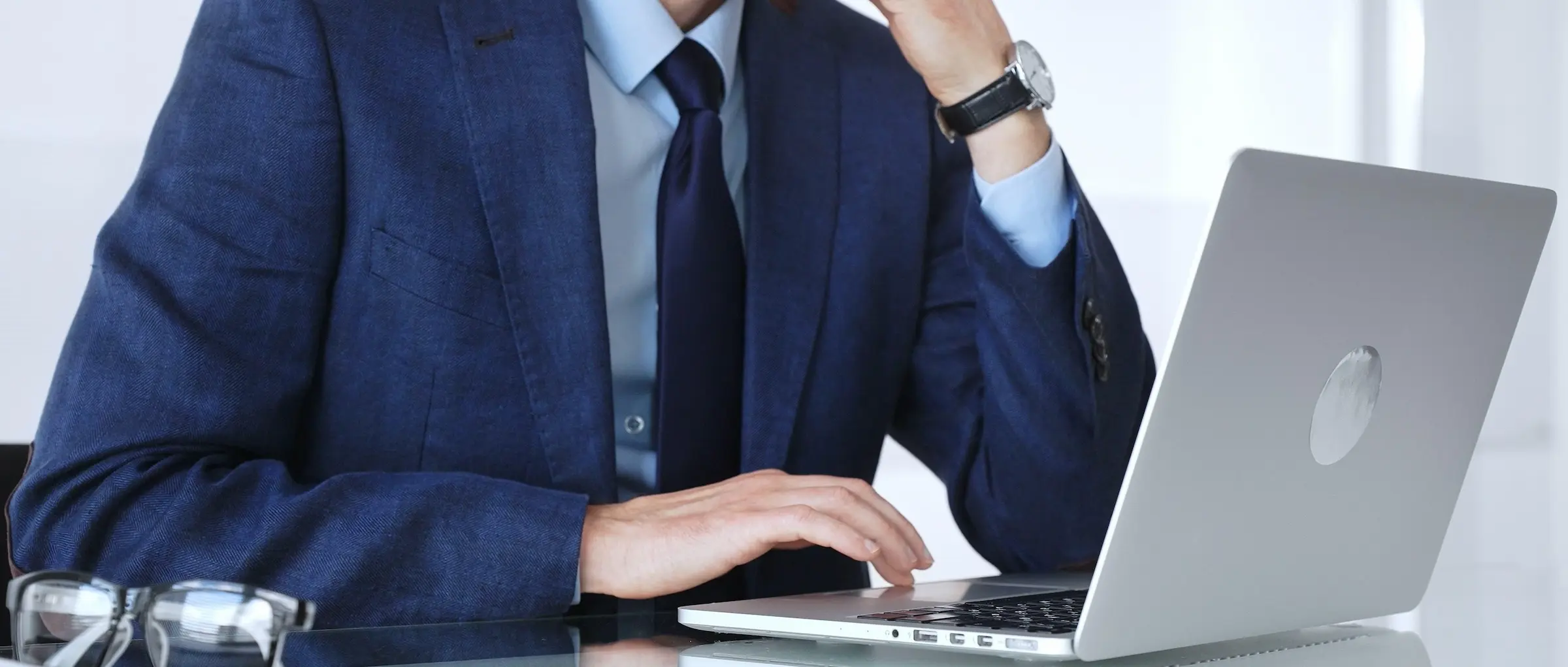 Luxury travel assistant managing VIP client requests on laptop